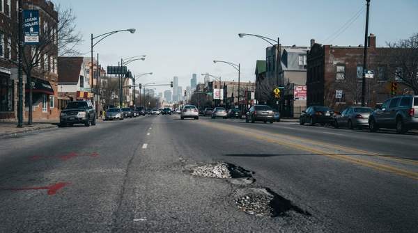 Editorial illustration for How Chicago Residents Can Report Potholes, Track Repairs, and File a Vehicle Damage Claim